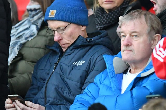 A Sunderland fan checks his phone during the game.