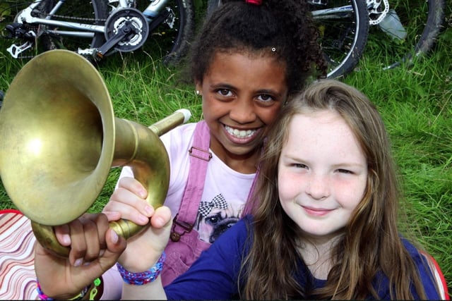 Olivie Campbell and Grace Stringer, both eight, with a French horn.