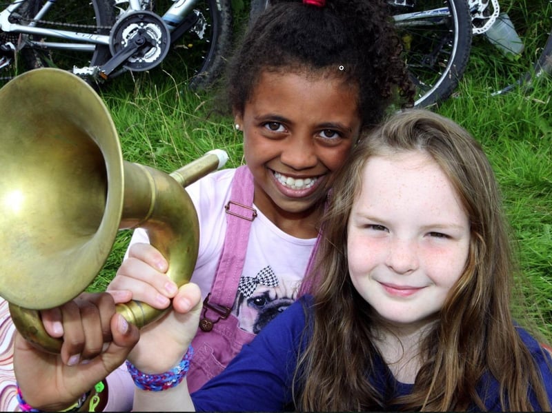 Olivie Campbell and Grace Stringer, both eight, with a French horn as they await the riders on the York to Sheffield stage of the Tour de France in 2014. We wonder if they will be cheering on the Tour de France Femmes next year?