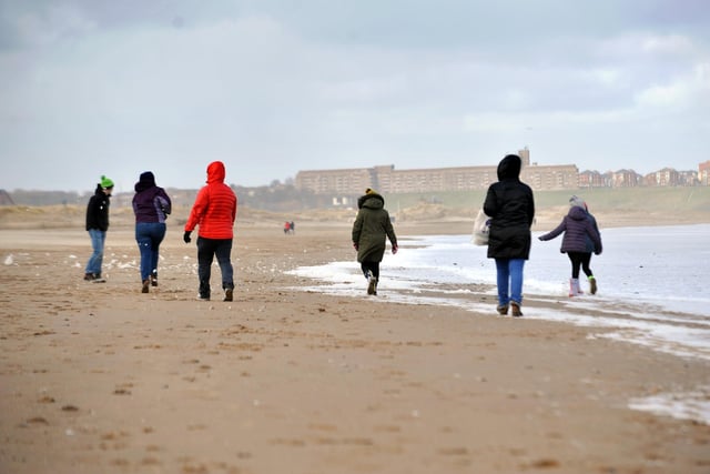 Walkers brave the cold easterly winds as they walk along Sandhaven Beach, South Shields in 2018.