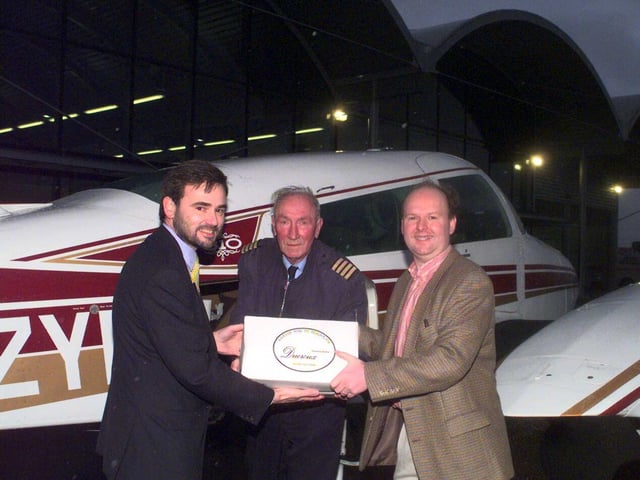 Pilot Les Meadows, of Eastern Air, hands over the first Beauolais Nouveau at Sheffield Airport to Andrew Coghlan, managing director of Barrels and Bottles. Helping is Jon Horne, left, managing director of Sheffield City Airport