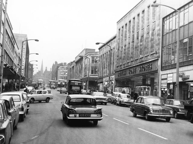 Traffic flows freely on The Moor, Sheffield, with Pauldens department store on the left and British Home Stores on the right
