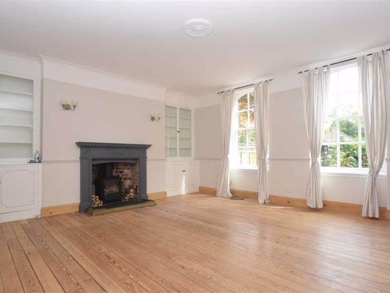 Large sitting room with log burner.