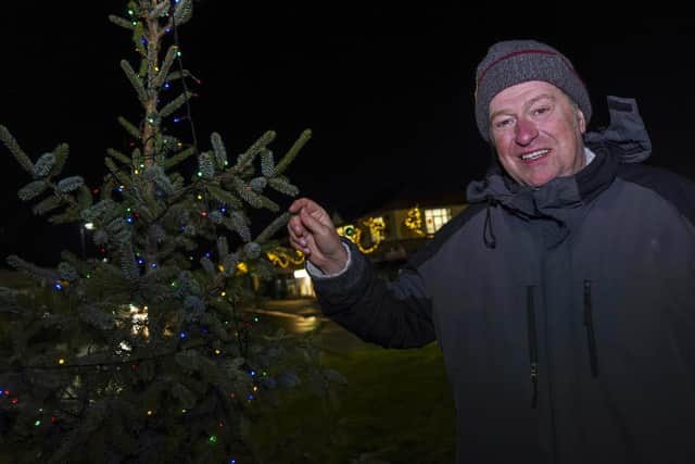 Kevin Palmer, one of the co-ordinators of the Facebook group, with some of the Christmas decorations in Greenhill before vandals struck