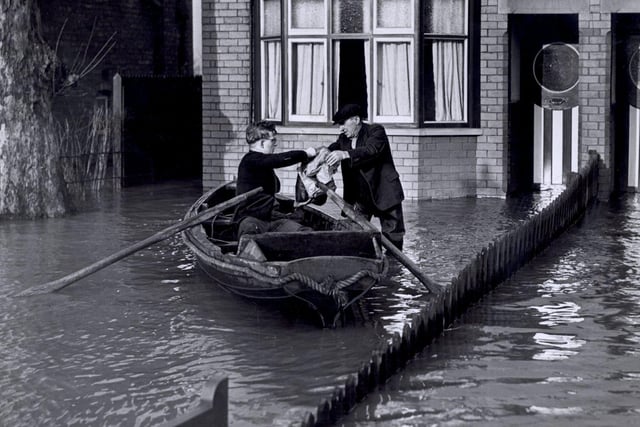 Groceries being delivered by boat at Bentley, Doncaster, during flooding there Feb 1941