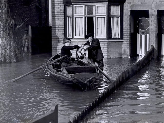 Groceries being delivered by boat at Bentley, Doncaster, during flooding there Feb 1941