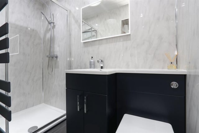 This smart and stylish en-suite leads off one of the bedrooms.