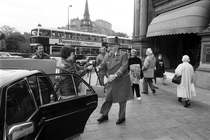 The doorman of Edinburgh's Caldeonian Hotel greets guests with a smile in June 1986.