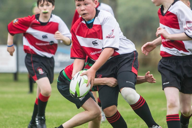 Lewis George on the ball for Peebles at Earlston's youth rugby festival