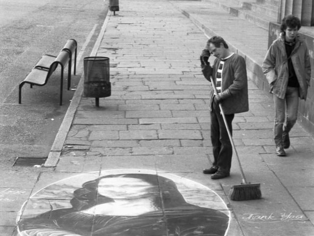 A road sweeper stops to admire a chalk drawing of the Mona Lisa on the pavement outside the Royal Scottish Academy in Edinburgh, September 1983.