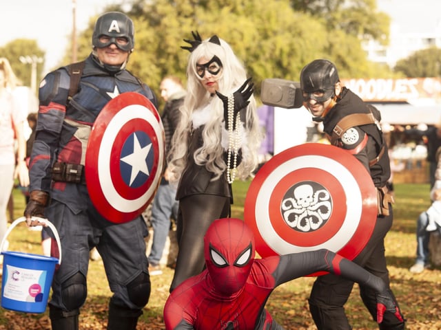 Superheroes Captain America and Spider-Man surround Cat Woman during the Great South Run 5k on Saturday, Photo: David Tiller
