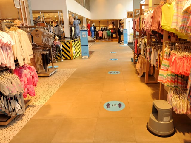 Two metre spacing is clearly marked on the floor.