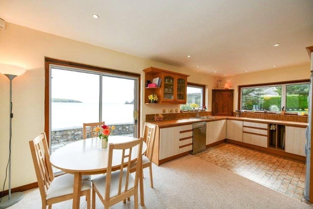 The spacious kitchen has a dining area and views out to the beach.