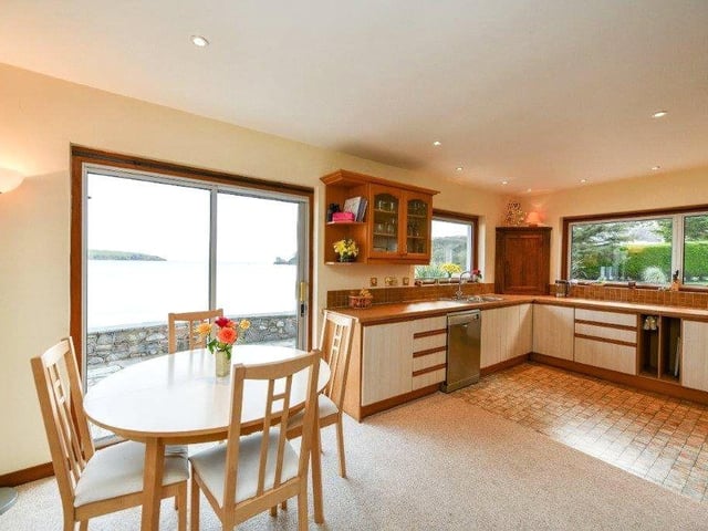 The spacious kitchen has a dining area and views out to the beach.