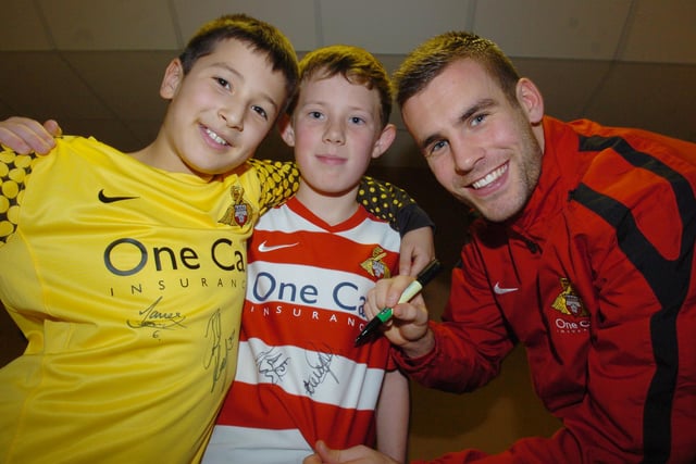 Tommy Spurr signs shirts at the Junior Rovers Christmas party in 2011
