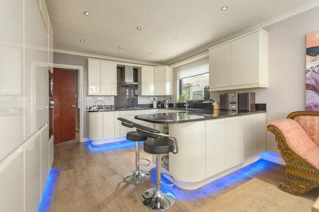 The kitchen/diner is another fabulous space boasting a range of wall and base units with attractive high gloss cream coloured doors with black granite work surfaces.