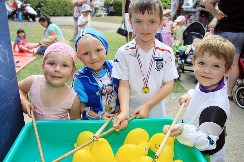 Ruby Knighton, Joe Sadler, Thomas Walker and Oliver Brown at the hook a duck stall at Brooksite playgroup's summer fair in Belper in 2010.