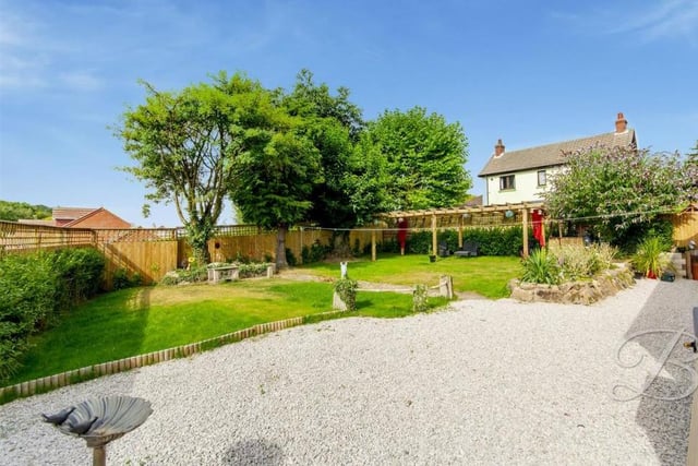 The sunny garden at the back of the property mixes a well-maintained lawn with mature shrubs and trees, and a gravelled area, suitable for barbecues. Roll on the summer!