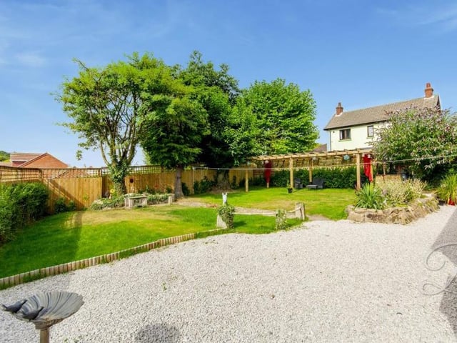The sunny garden at the back of the property mixes a well-maintained lawn with mature shrubs and trees, and a gravelled area, suitable for barbecues. Roll on the summer!