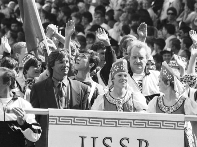 American actor Don Johnson leads the USSR team into Glasgow's Celtic Park for the European Special Olympics in July 1990.