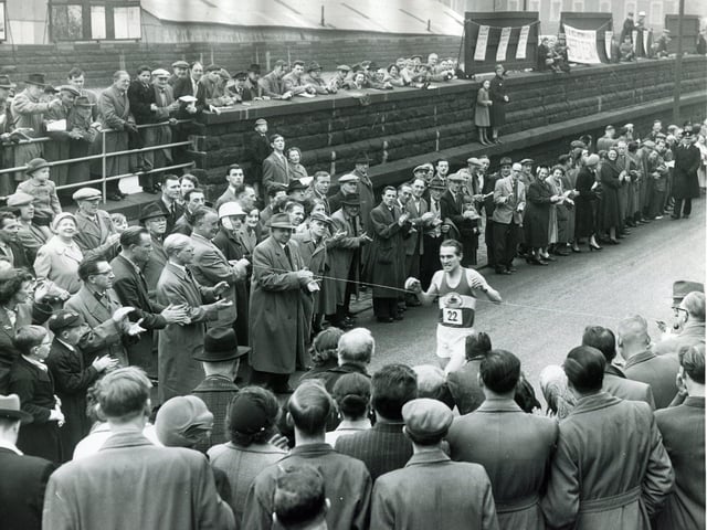 A P Keily comes in to win the Sheffield Telegraph's 12th annual Easter Marathon from Doncaster to Sheffield on April 22, 1957