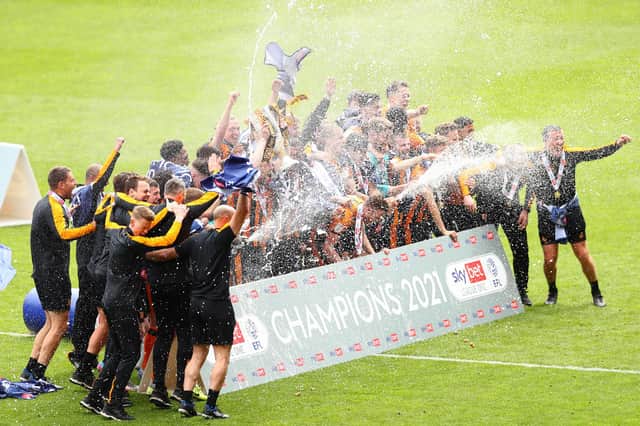 LONDON, ENGLAND - MAY 09: The Hull City squad celebrate with the Sky Bet League One trophy following the Sky Bet League One match between Charlton Athletic and Hull City at The Valley on May 09, 2021 in London, England.  (Photo by Jacques Feeney/Getty Images)