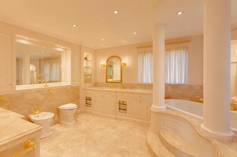 With recessed lighting, marble tiled walls/flooring and a suite in white, which comprises of a low level WC, bidet, two wash hand basins with mixer taps, panelled bath with mixer tap and hand shower facility. Additionally having a shower enclosure with rain head shower and separate hand shower facility.