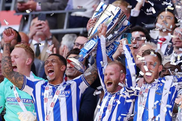 LONDON, ENGLAND - MAY 29: Liam Palmer and Barry Bannan of Sheffield Wednesday celebrate while holding the trophy alongside their teammates after the team's victory and promotion to the Sky Bet Championship in the Sky Bet League One Play-Off Final between Barnsley and Sheffield Wednesday at Wembley Stadium on May 29, 2023 in London, England. (Photo by Richard Heathcote/Getty Images)