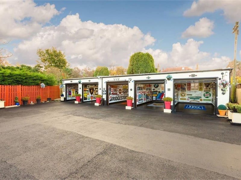 Borders have been created with stone chippings and the current owner has made the space into a place well-suited to an ardent car enthusiast.