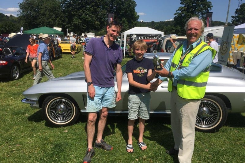 Corrin Mellor, pictured with his son, receives the best car award for his 1966 5.2 litre Chevrolet Sting-Ray from Matlock Rotary Club president Tom Moloney.