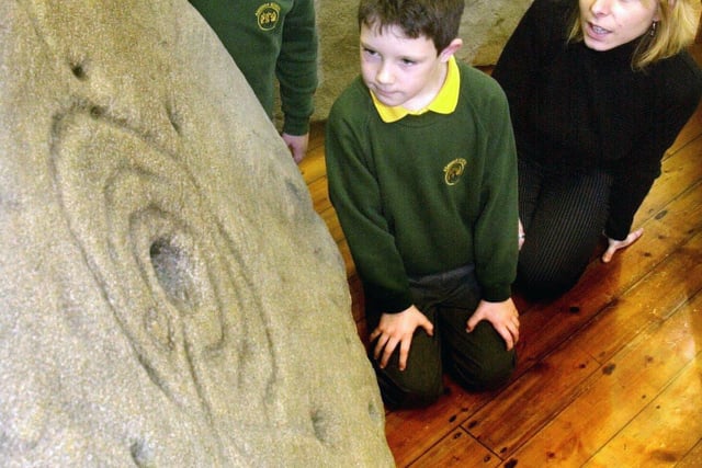 Pupils Georgina Workman and Jack Malden both aged 7 years and teacher Marisa Signora   looked at the life size replicas of the Ashover Rock Art, two unique pices of Bronze Age cup and rock art discovered in the grounds of their school Ashover Primary, Ashover near Chesterfield in 2003