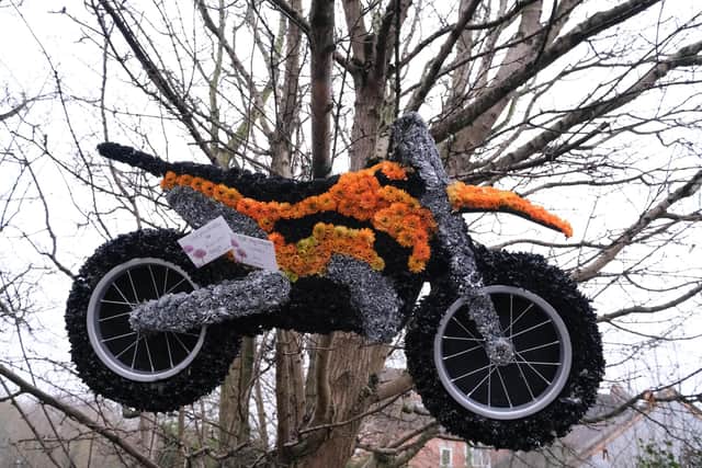 A flower display in the shape of a motorbike left outside the Gypsy Queen.