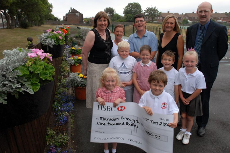 Pupils, staff and parents from Marsden Primary School were given a cheque for £1,000 from HSBC towards their school garden project in 2006.