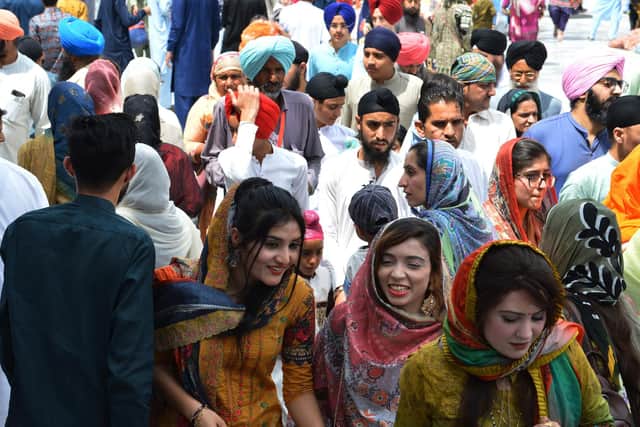 Sikh devotees walk at the Gurdwara Panja Sahib during the annual 'Baisakhi' festival, a spring harvest festival for Sikhs and Hindus, in Hasan Abdal on April 14, 2022. (Photo by Farooq NAEEM / AFP) (Photo by FAROOQ NAEEM/AFP via Getty Images)
