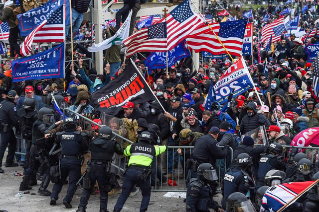 Trump supporters clash with police and security forces as they storm the US Capitol in Washington, DC on January 6, 2021. - Demonstrators breeched security and entered the Capitol as Congress debated the a 2020 presidential election Electoral Vote Certification. (Photo by ROBERTO SCHMIDT / AFP)
