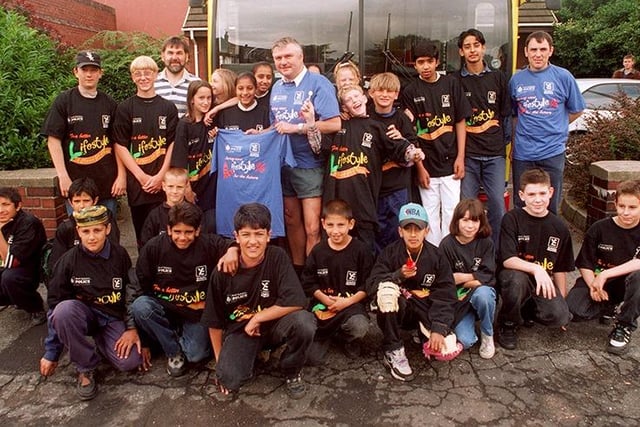 PC Stuart Hancock, centre, with Tinsley Lifestyle youngsters before their trip to Cleethorpes Pleasure Island Theme park which was arranged as a thank you for their cleanup around Tinsley and other charity work, July 1996