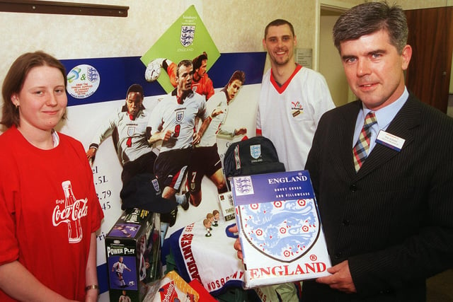 Pictured at Sainsbury's store Archer Road, Sheffield, in 1998 where the World Cup Memorabilia was auctioned off for charity. Seen with the items LtoR are,  Claire Ogden, Andy Bate, and  Deputy Manager Phil Ronan.