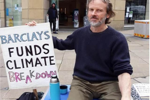 Dr Mike Nutt holds a weekly protest outside Barclays bank because of its involvement in fossil fuels
