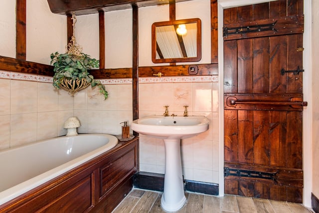 The bathroom has a classic style suite.