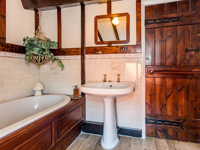The bathroom has a classic style suite.
