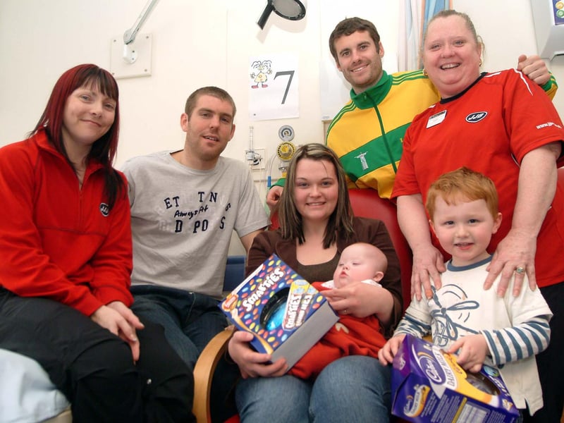Mansfield Town FC players present Easter eggs to children on the Robin Hood ward at King's Mill Hospital on behalf of JJB Fitness Club.
Pictured, from left, are Tracy Clements, of JJB, Stags player Jake Buxton, Vicki Caylow from South Normanton with five-month-old baby Frankie, Keith Briggs, of Mansfield Town FC and Tracey Howard, of JJB, with Frankie's brother, William, aged three.