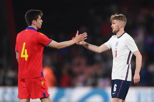 Tommy Doyle of England embraces Joan Bellido of Andorra after the UEFA European Under-21 Championship Qualifier match between England U21 and Andorra U21 at Dean Court on March 25, 2022 in Bournemouth, England. (Photo by Mike Hewitt/Getty Images)
