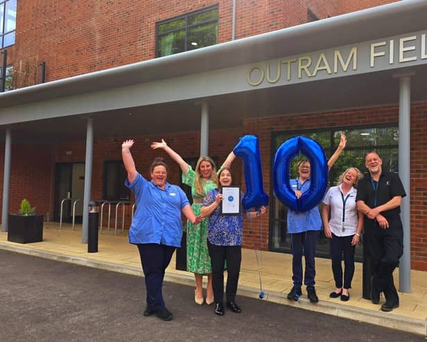 Staff at Outram Fields celebrating the care home's 10 out of 10 review score