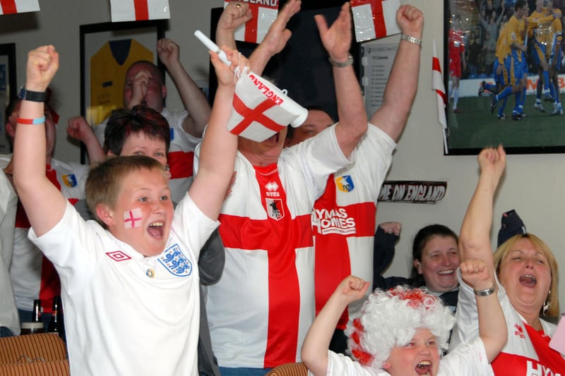Mansfield Town staff and fans watch England's first match in the 2010 World Cup.