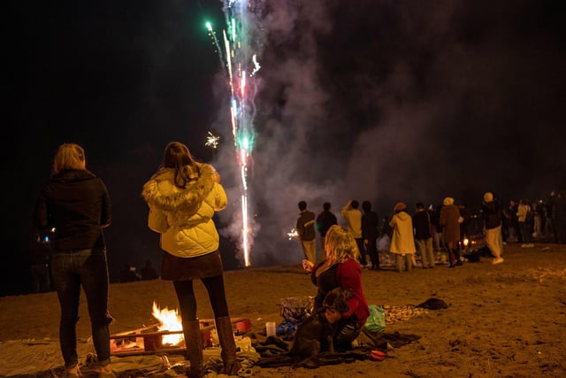 Locals gathered round their bonfires, and watched the colourful pyrotechnic display.