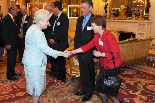 Helen Sharman and Michael Palin meet the Queen