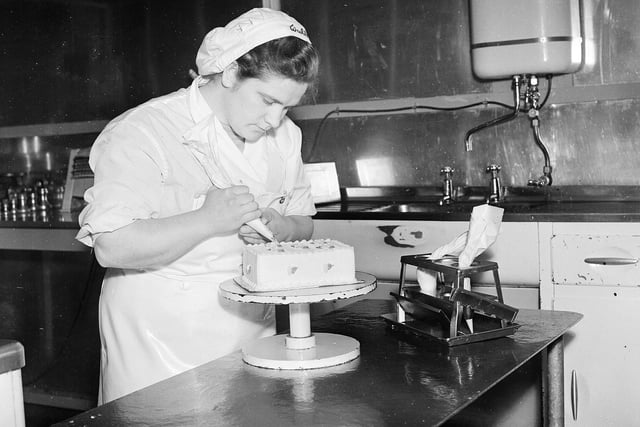Lilian Malcom, a decoration specialist, creating an ice-cream gateaux at the Walls Ice Cream Factory, in Craigmillar, in March 1955.