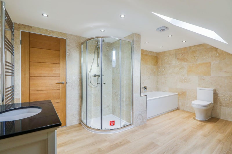 Fitted with an attractive, four-piece, white and chrome suite, comprising double-ended bath, separate shower cubicle, low-suite WC and vanity wash basin.