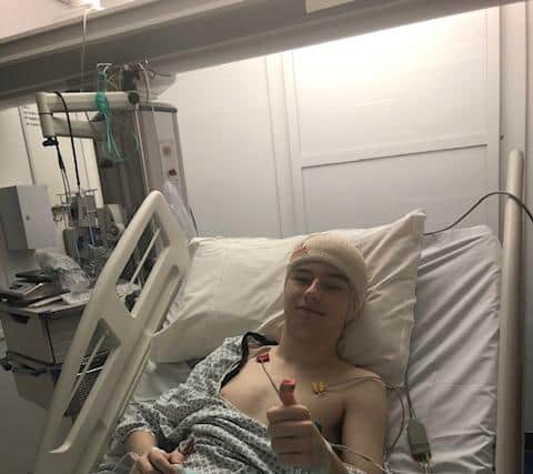 Jake giving the thumbs up after the surgery.