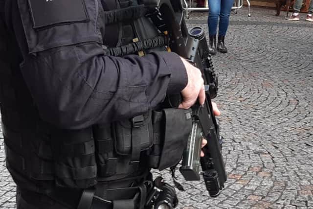 Two people have been arrested and a man injured after shots were fired in East Dene, Rotherham. File picture shows a South Yorkshire Police firearms officer